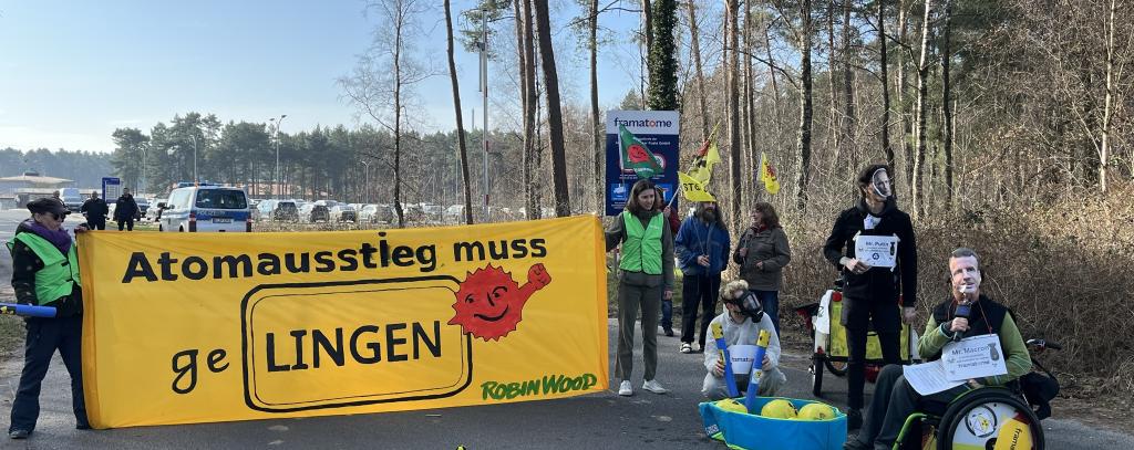 Demonstrierende mit gelbem Banner für die Stilllegung der Atomfabrik in Lingen