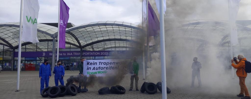 Protest bei der IAA Nutzfahrzeuge in Hannover gegen Tropenwaldzerstörung für Autoreifen, 20.09.22 (Foto: ROBIN WOOD) Protest mit Qualm, alten Autoreifen u. Banner gegen Tropenwaldzerstörung für Autoreifen