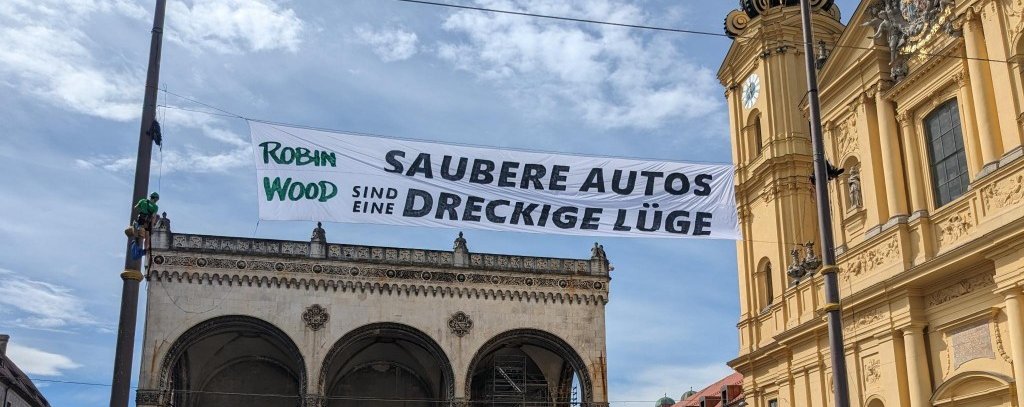 Saubere Autos sind eine dreckige Lüge – Bannerprotest von ROBIN WOOD-Aktivist*innen gegen die anstehende Auto-Show IAA in München, 01.09.2023 (Foto: ROBIN WOOD)