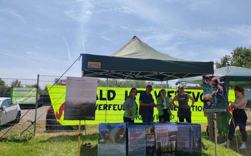 Aktive an einem Infostand vor Pelletwerk